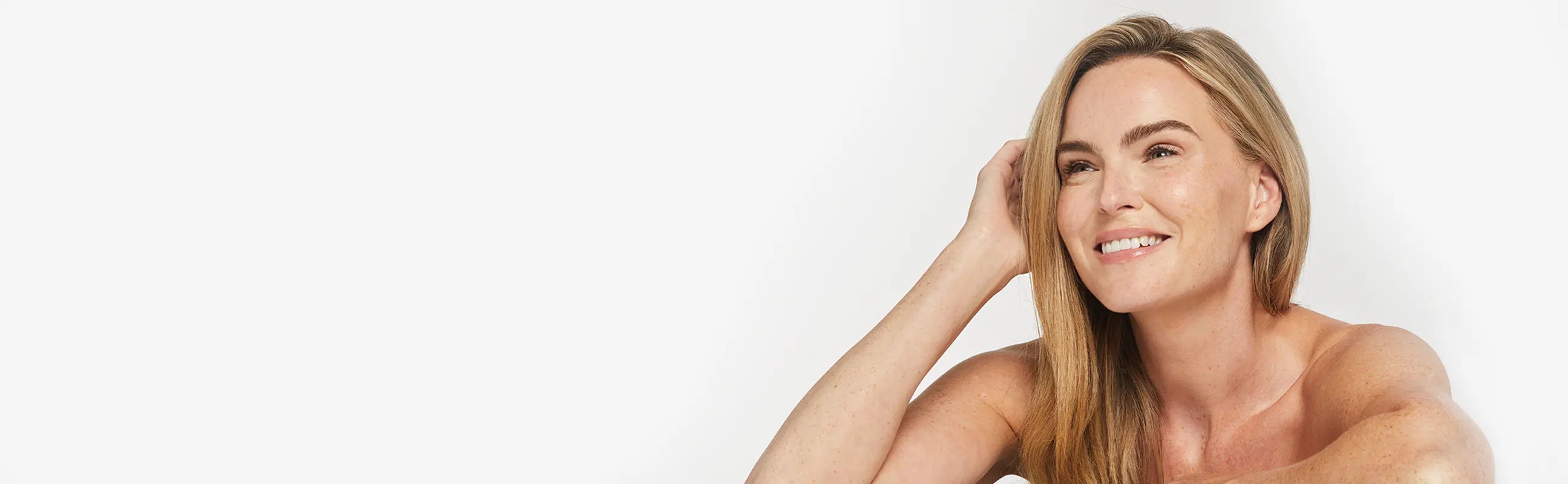 Woman with long blonde hair against a white background